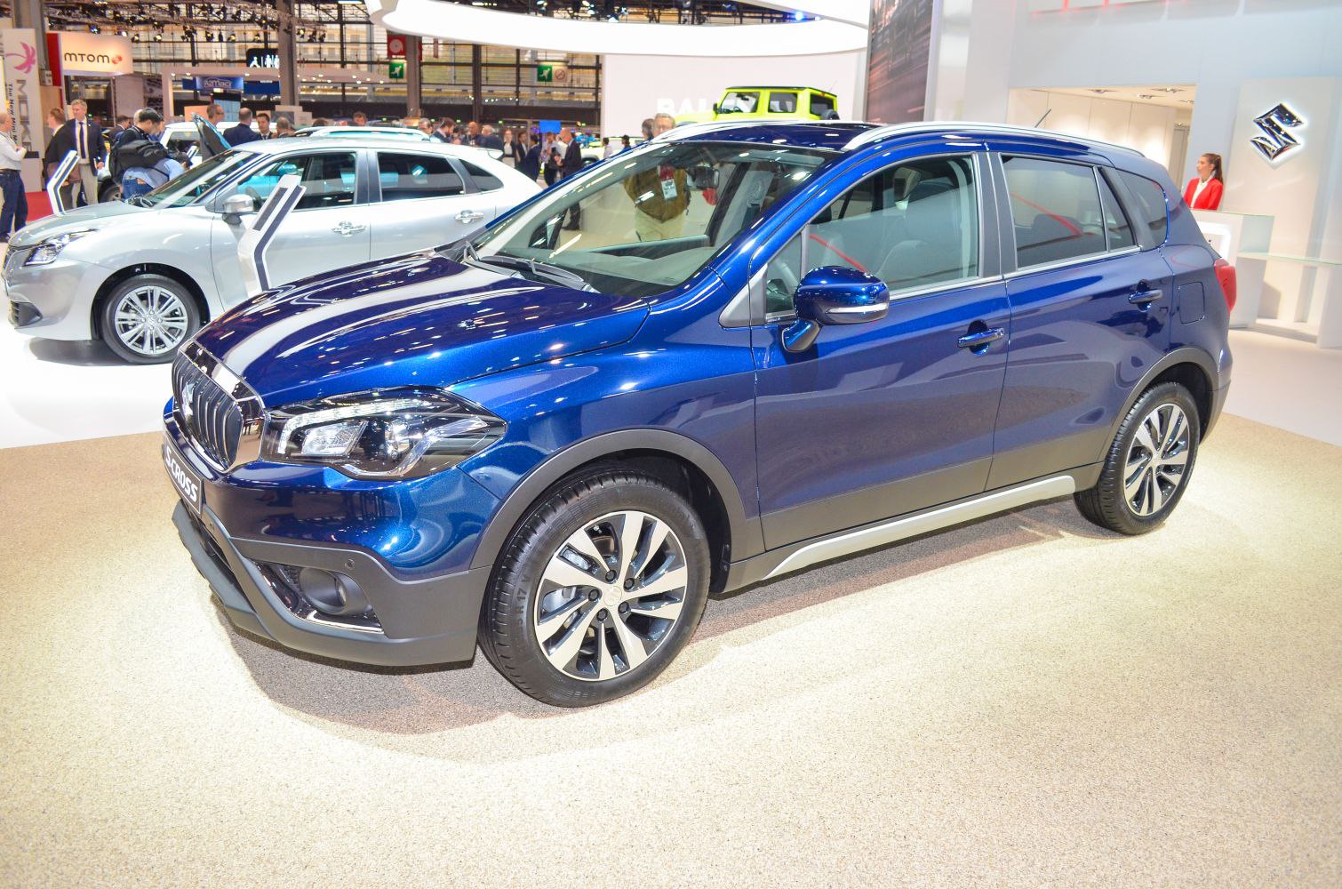 Blue compact SUV with alloy wheels and modern design showcased indoors