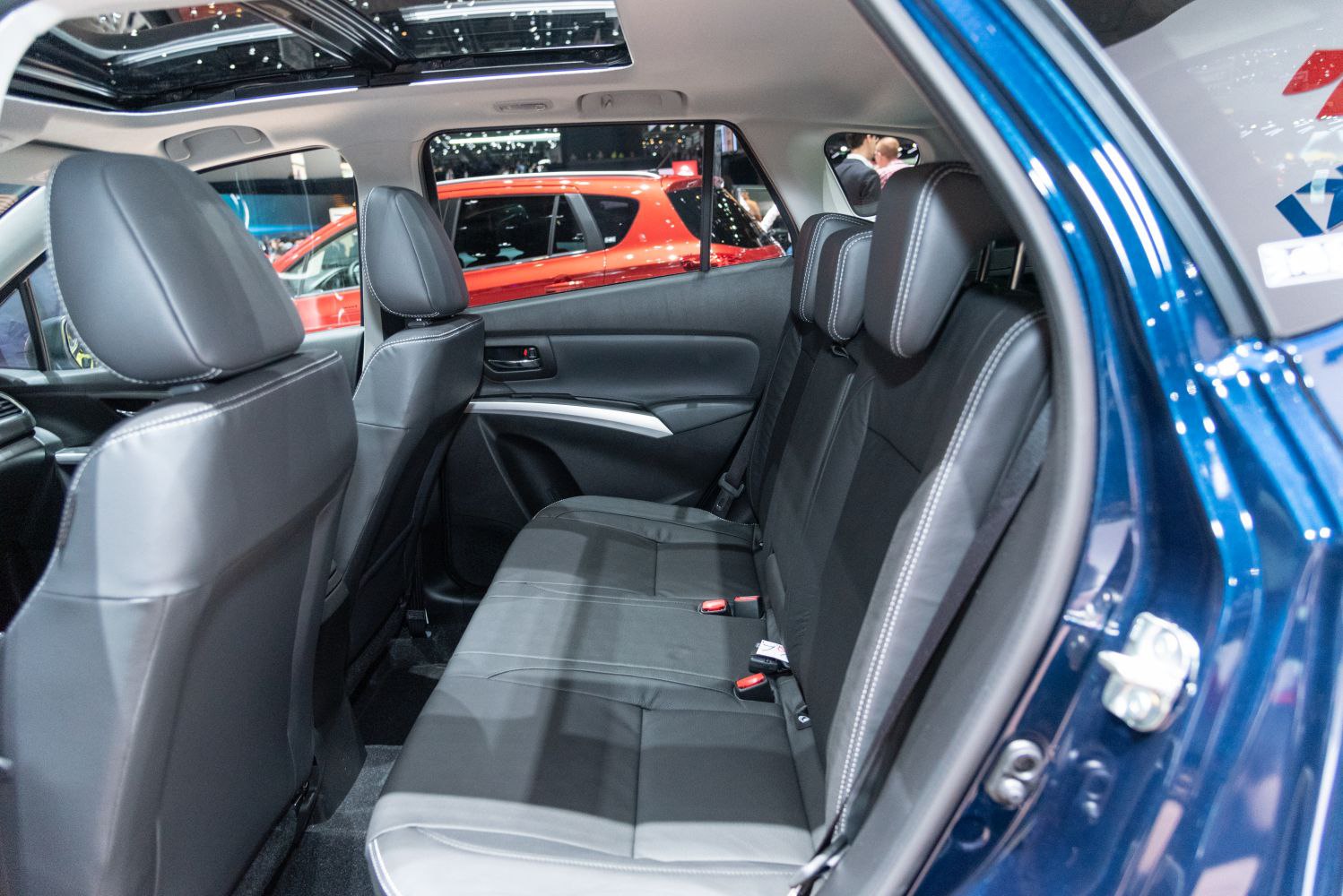 Leather rear passenger seats and interior door panel with modern design.