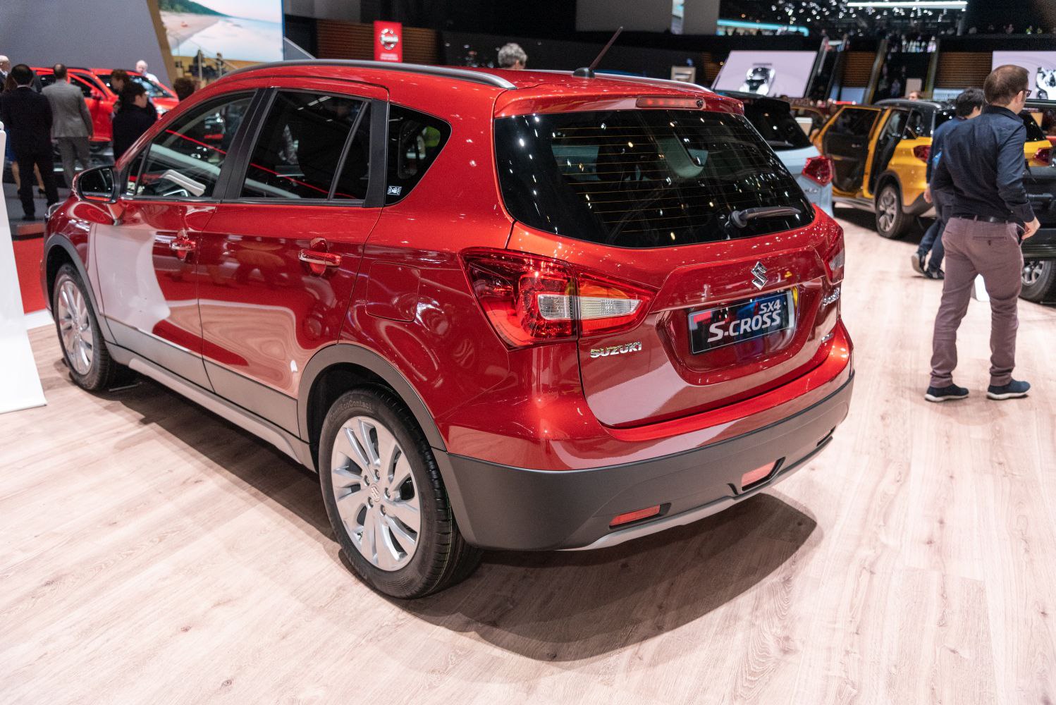 Rear view of red compact SUV with tail lights and roof rails
