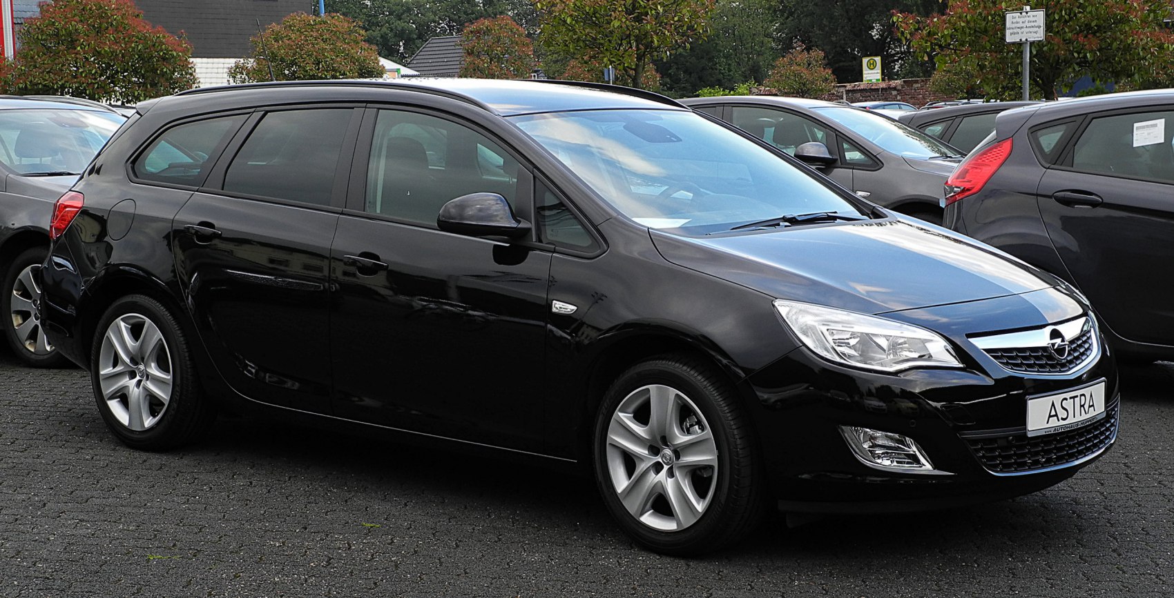 Black estate car side profile with alloy wheels and modern headlights