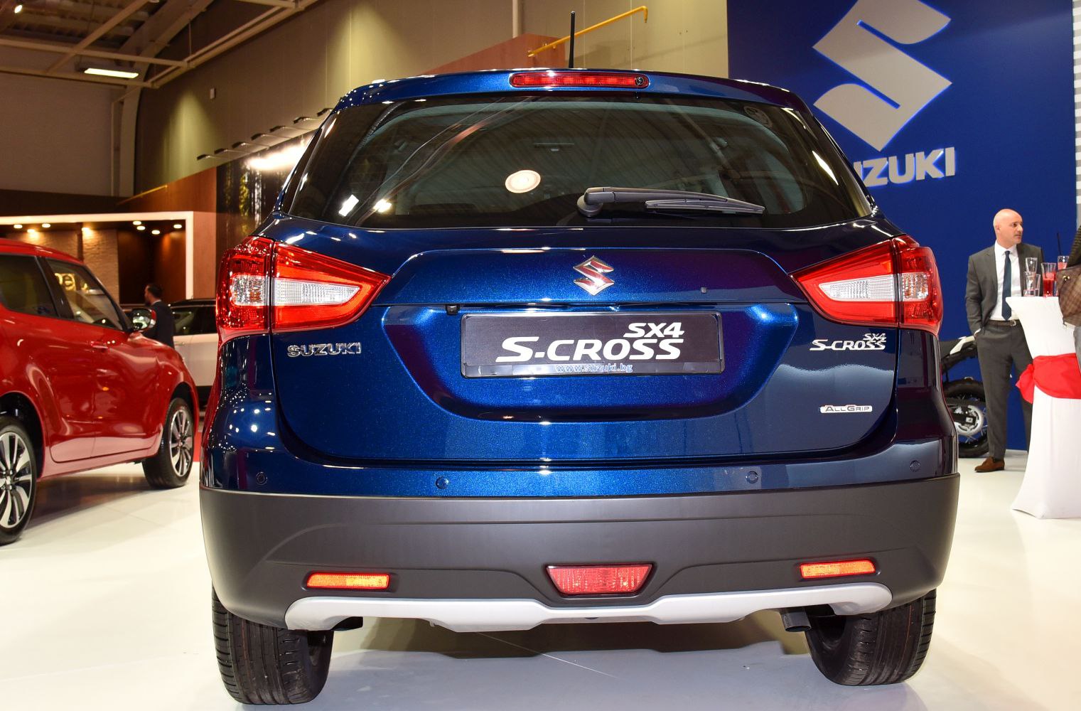 Rear view of a blue SUV with taillights and rear windshield wiper