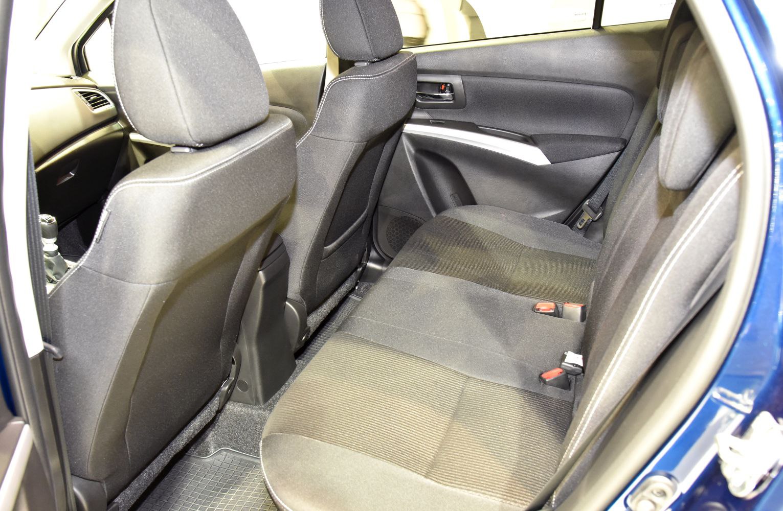Rear passenger seat and interior door panel with fabric upholstery