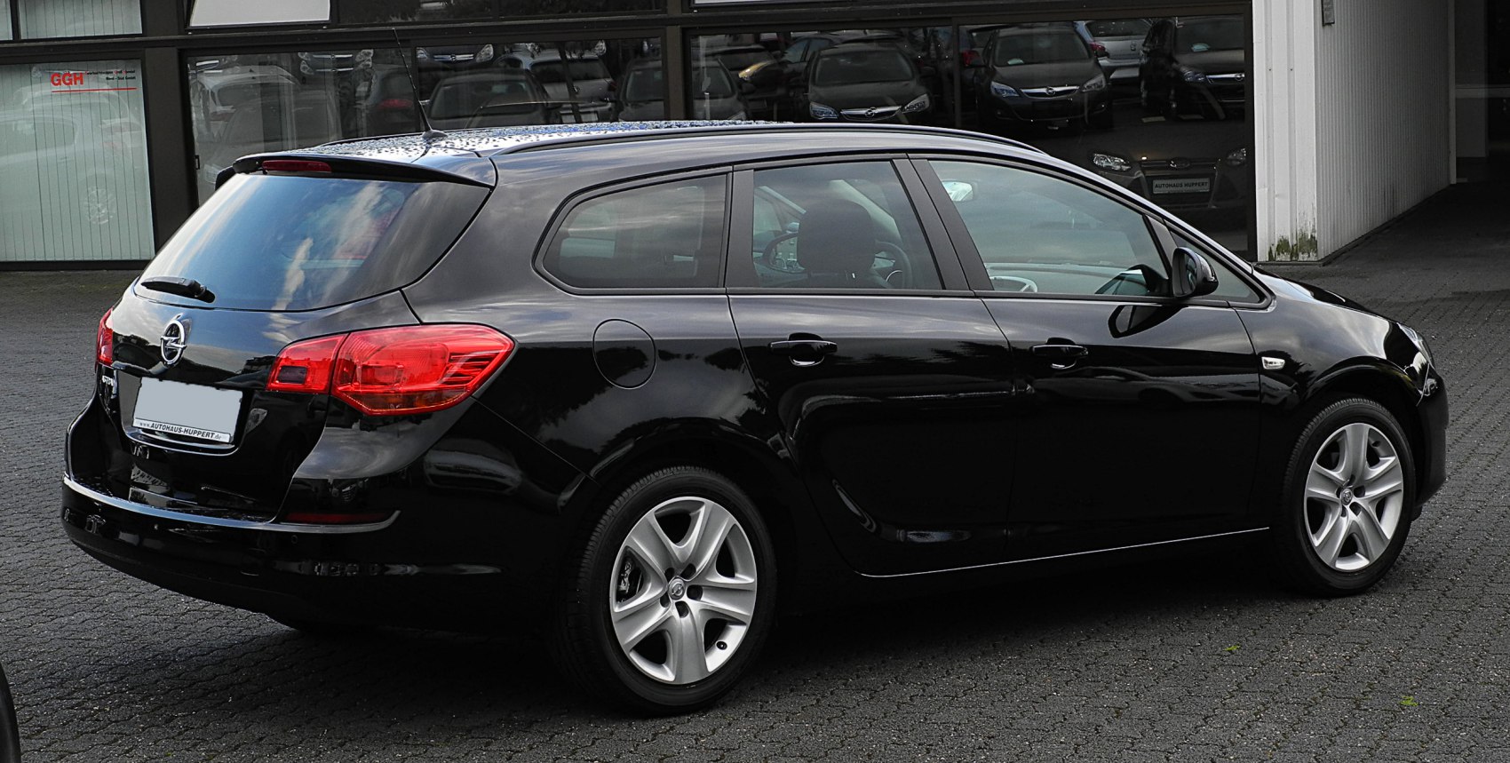 Black station wagon exterior with rear and side view, alloy wheels and distinctive tail lights.