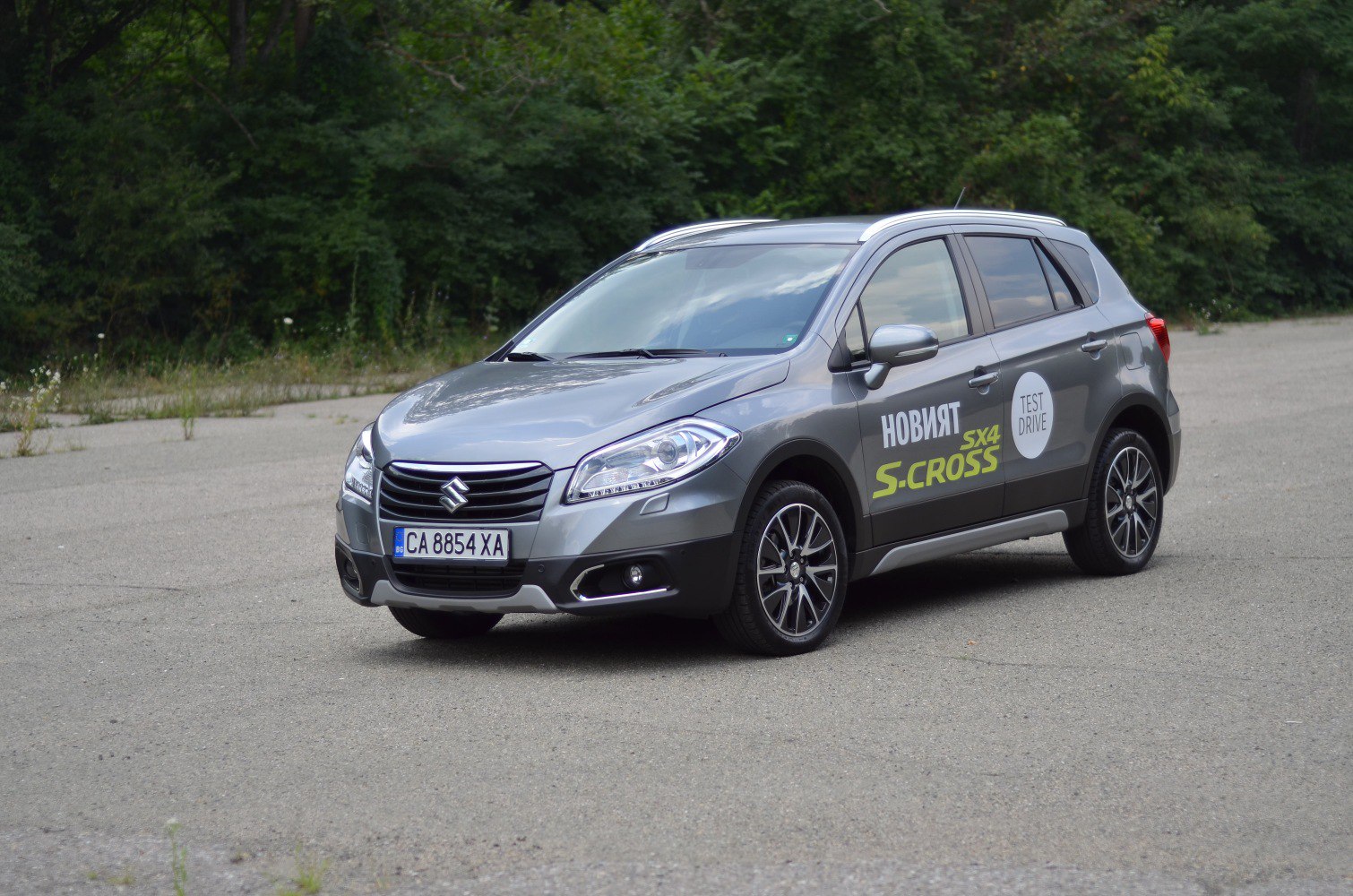Front side view of a crossover with test drive decals and alloy wheels