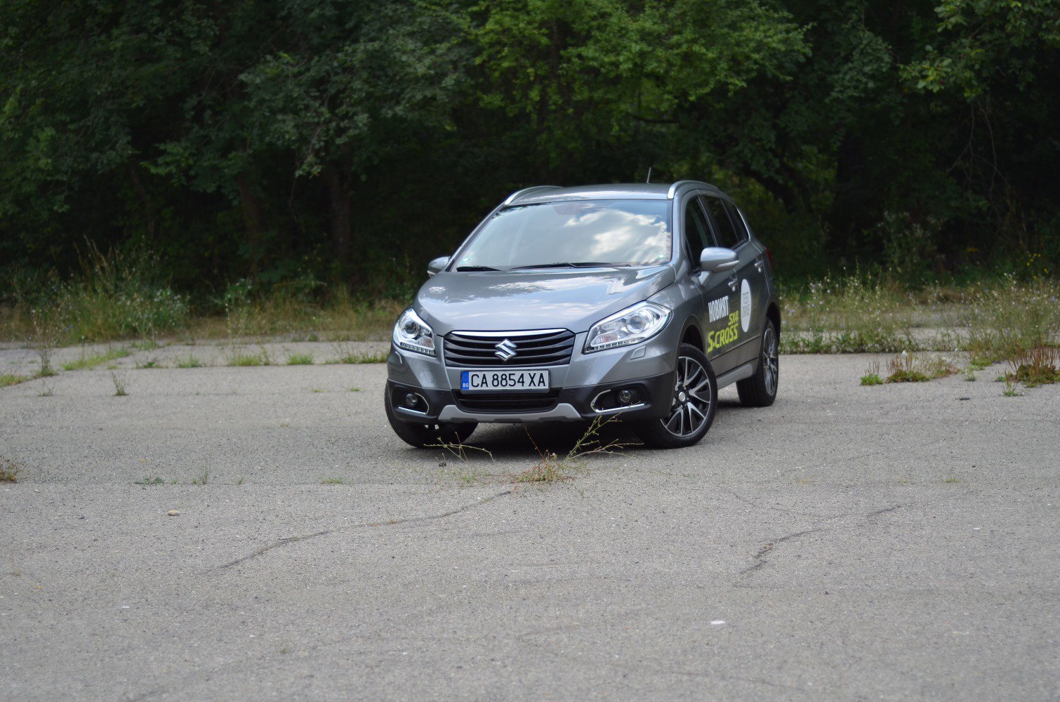 Front view of a silver crossover with modern headlights and grille.