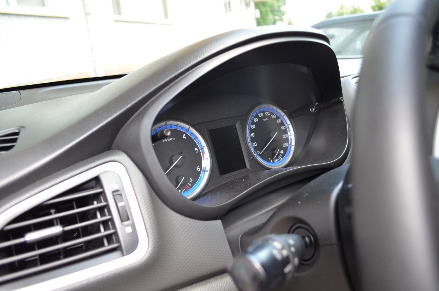 Dashboard instrument cluster with speedometer and tachometer