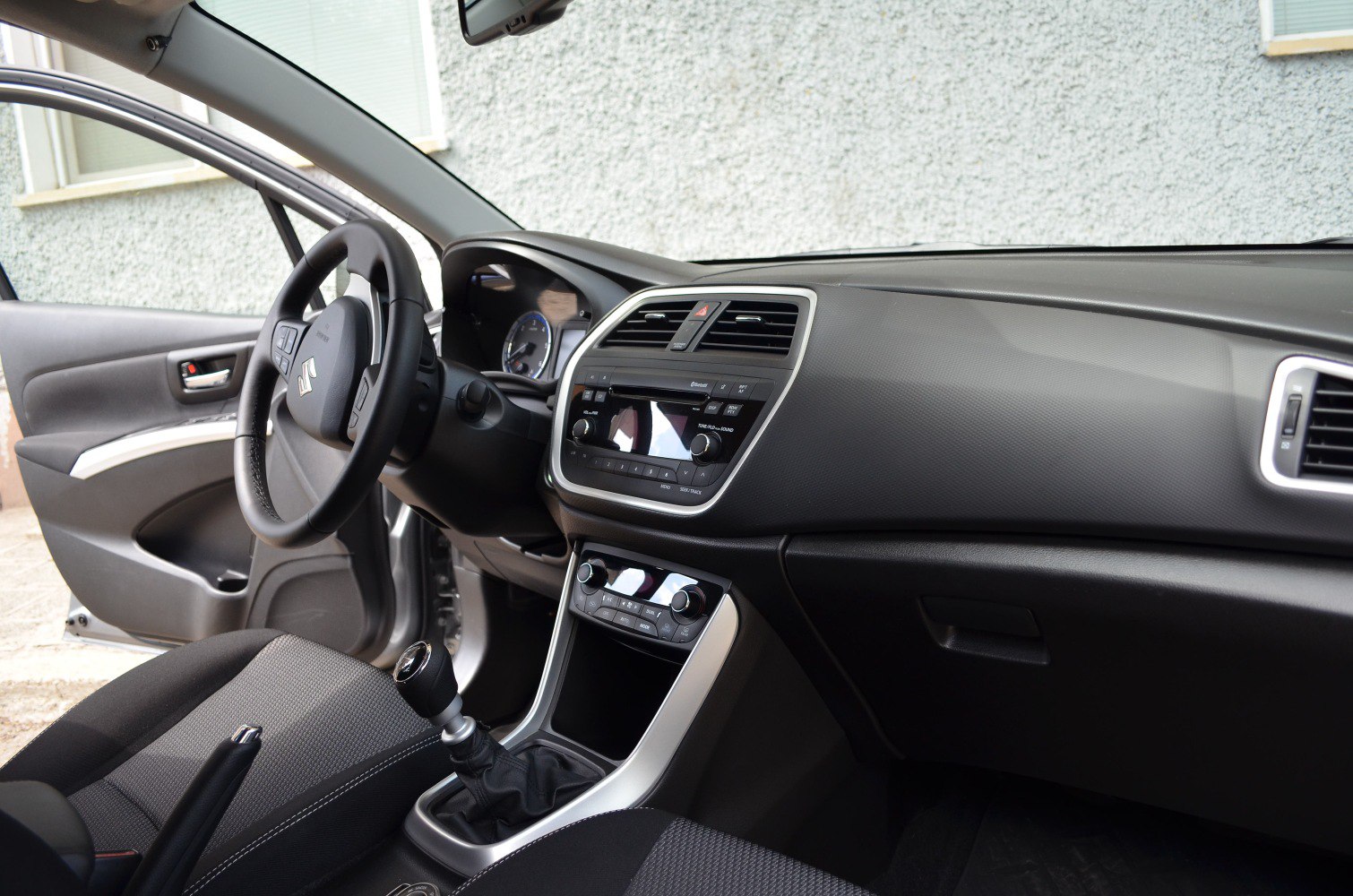Car interior dashboard and manual gear shift from driver's perspective