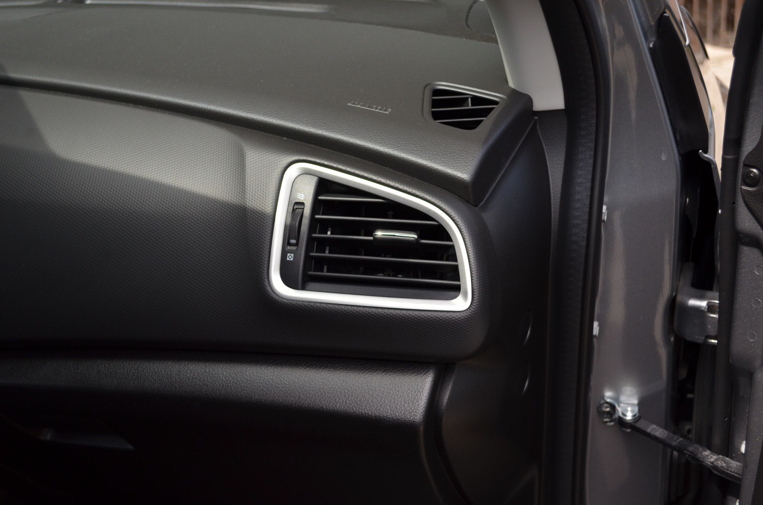 Car interior dashboard with close-up of an air vent