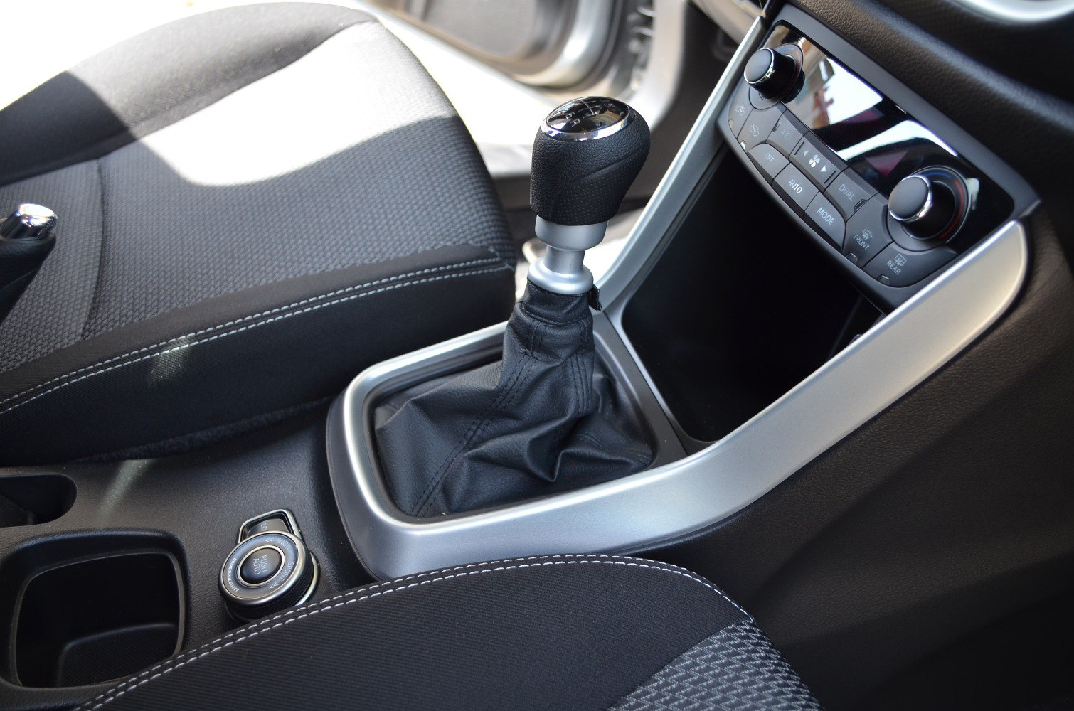 Manual gear shift knob and center console with climate control knobs