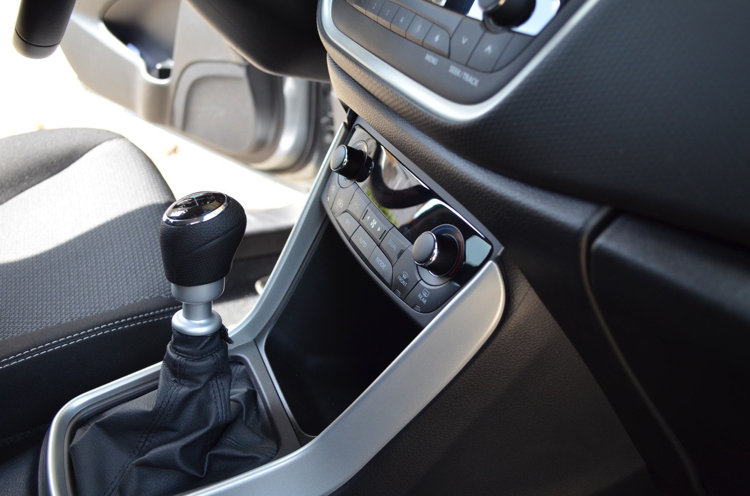 Manual gear shift lever and climate control panel with knobs