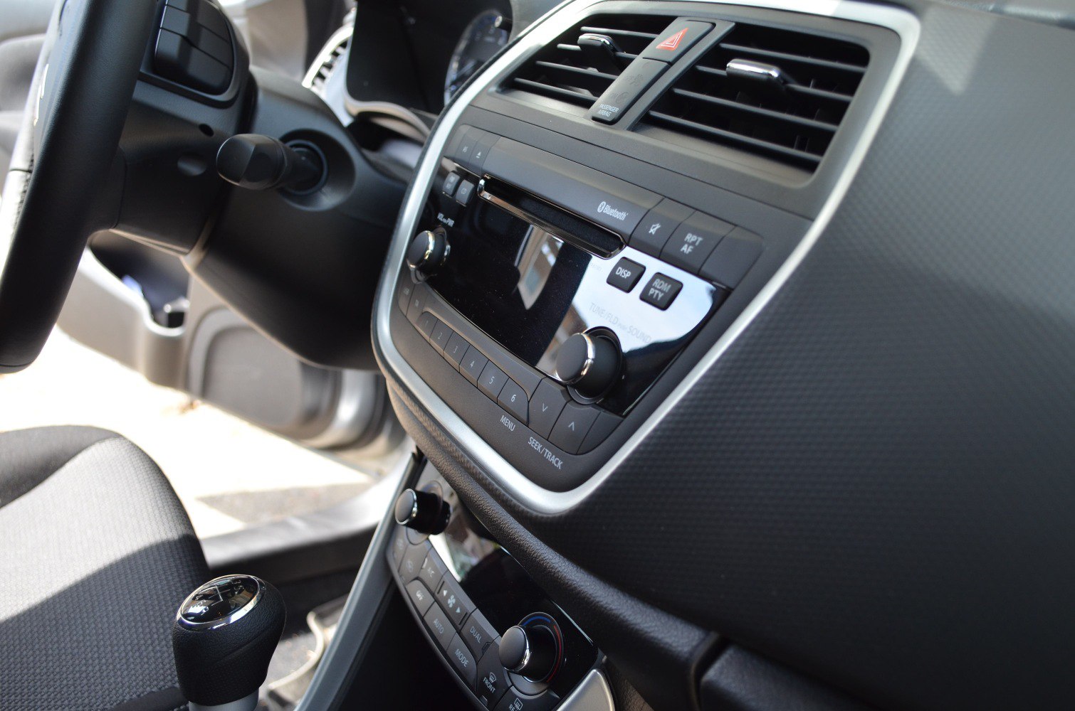 Dashboard with central control panel and gear shift knob.