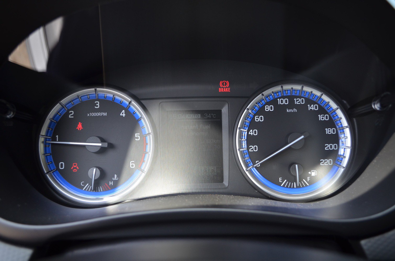 Instrument cluster with tachometer, speedometer, and digital display
