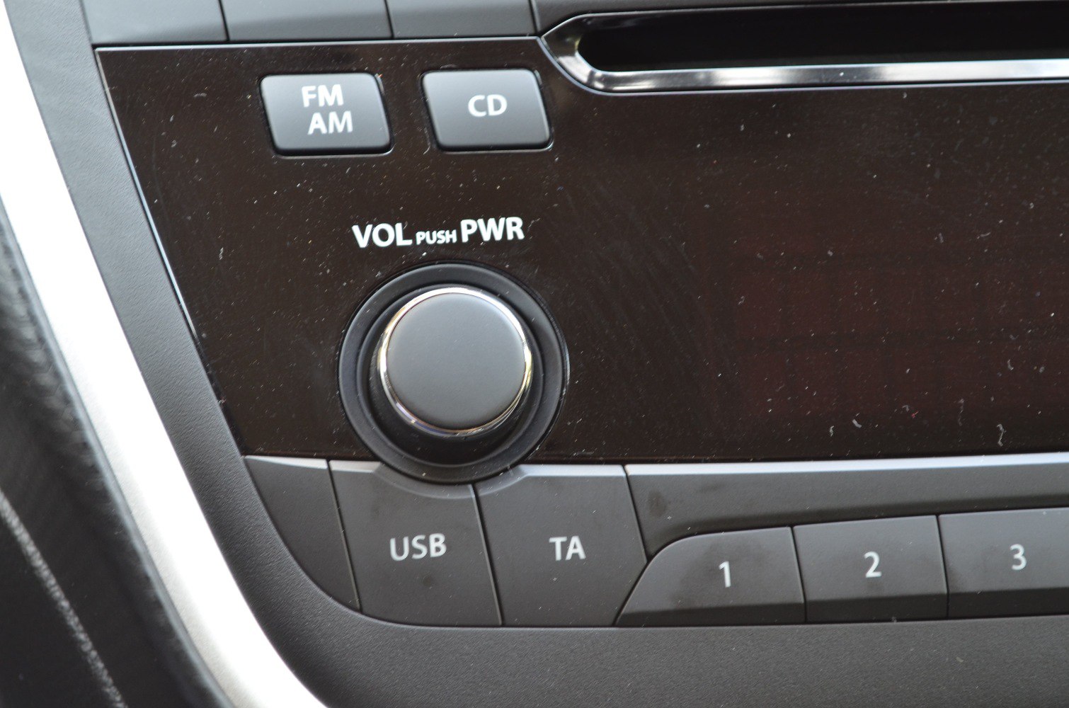 Radio control panel with volume knob, USB port, and preset buttons