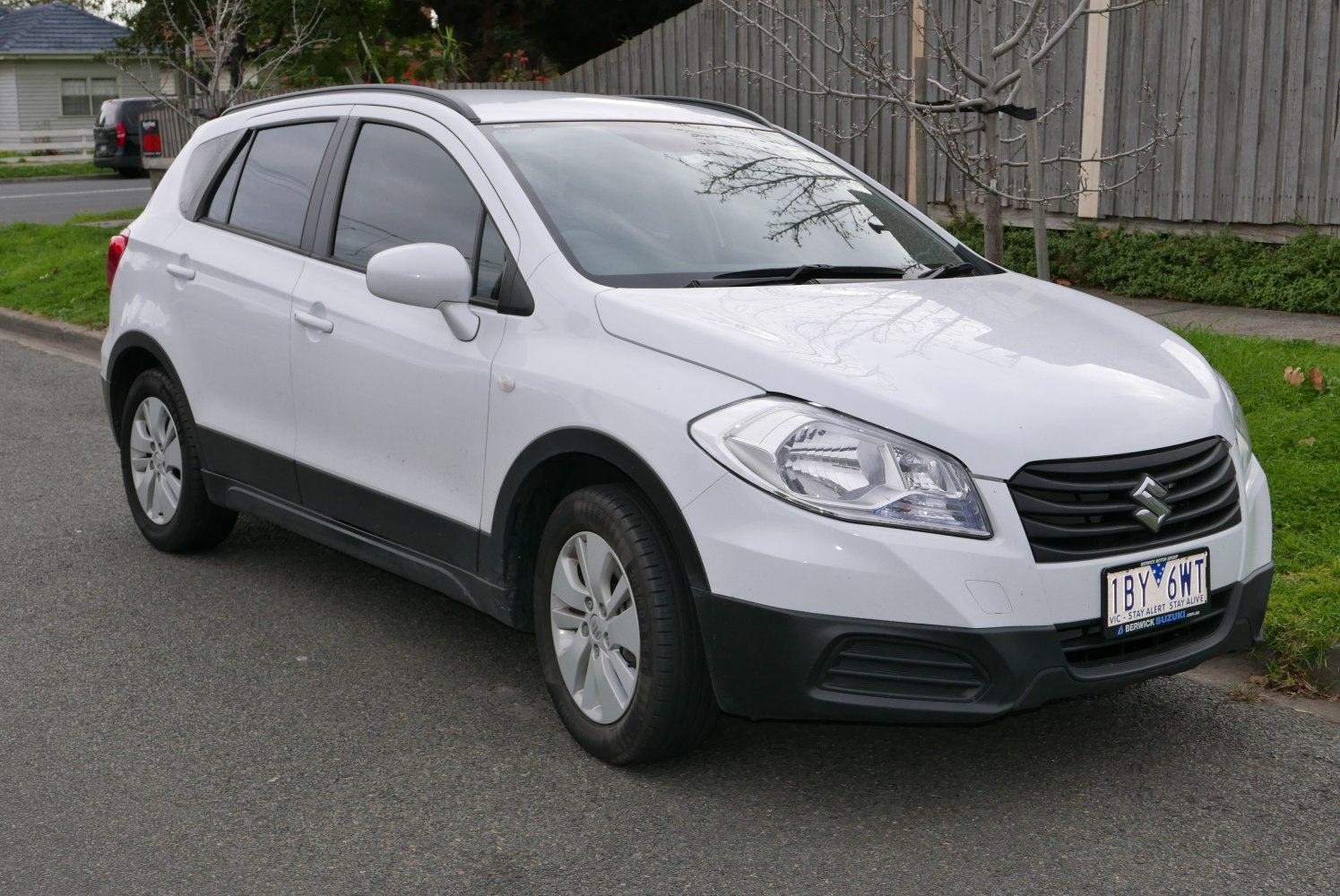 Front-side view of compact SUV with bold grille and sleek headlights