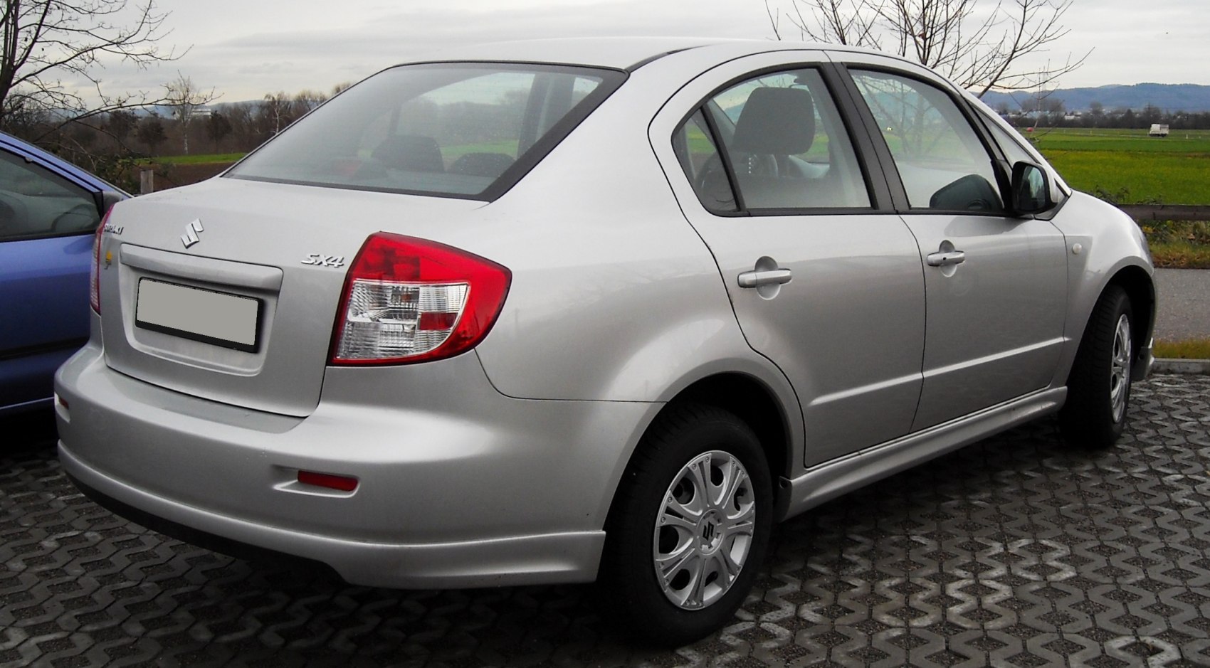 Silver sedan with distinctive tail lights and smooth body lines