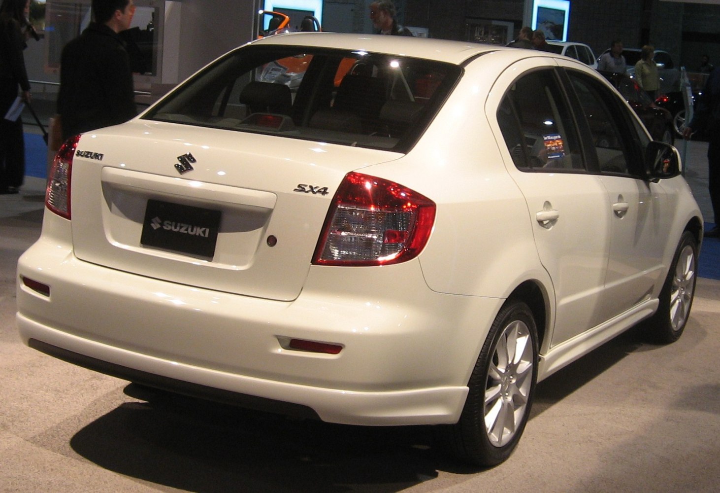 Rear view of compact four-door sedan with clear taillights and prominent trunk design.