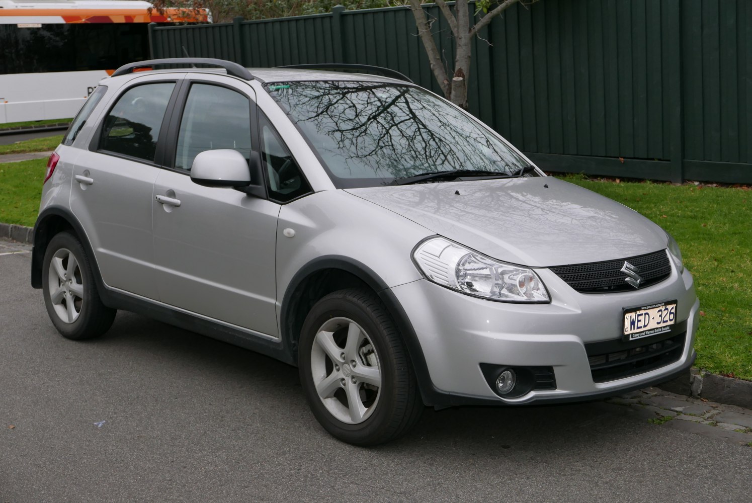 Front-side view of a silver compact crossover with roof rails and alloy wheels