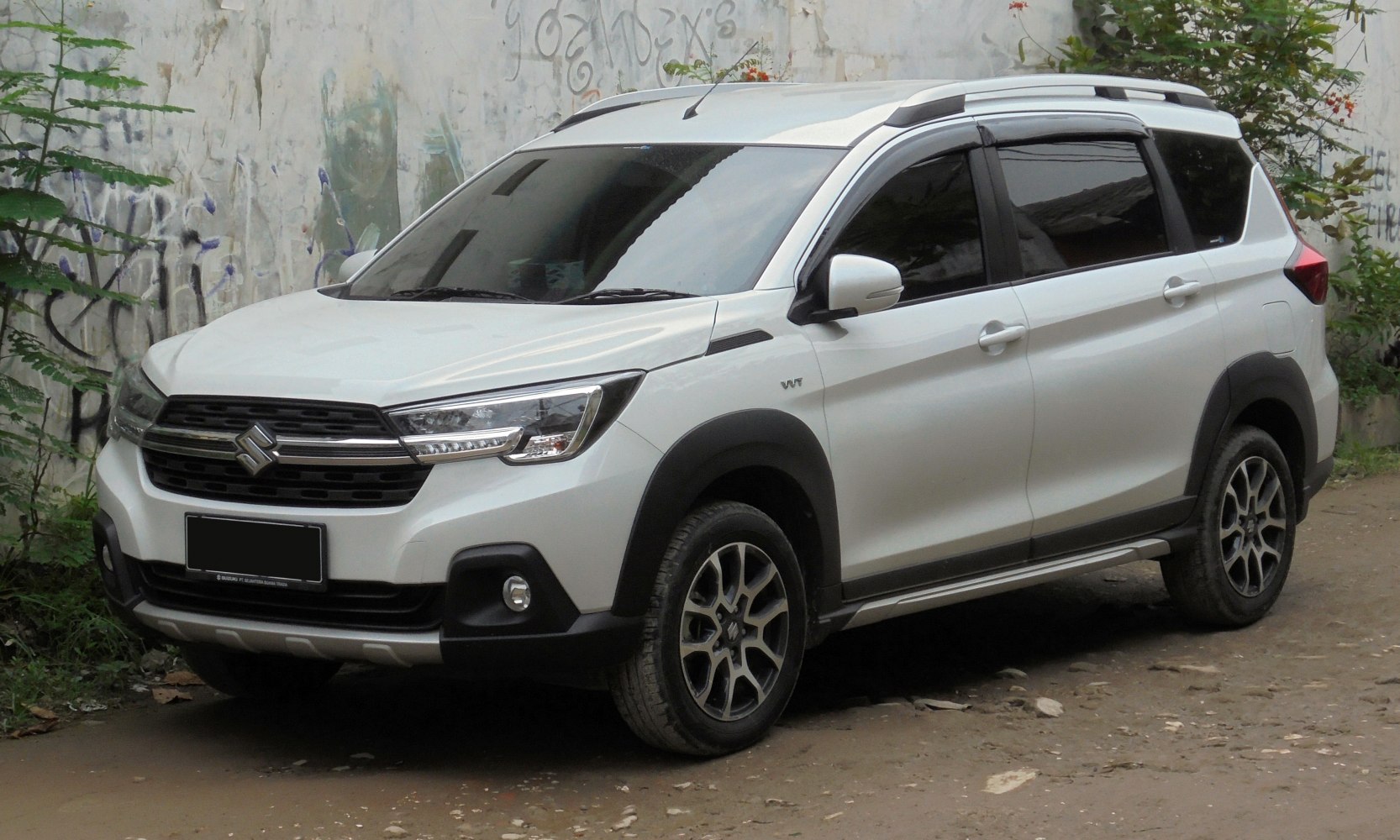 Front side view of a modern SUV with tinted windows and rugged trim