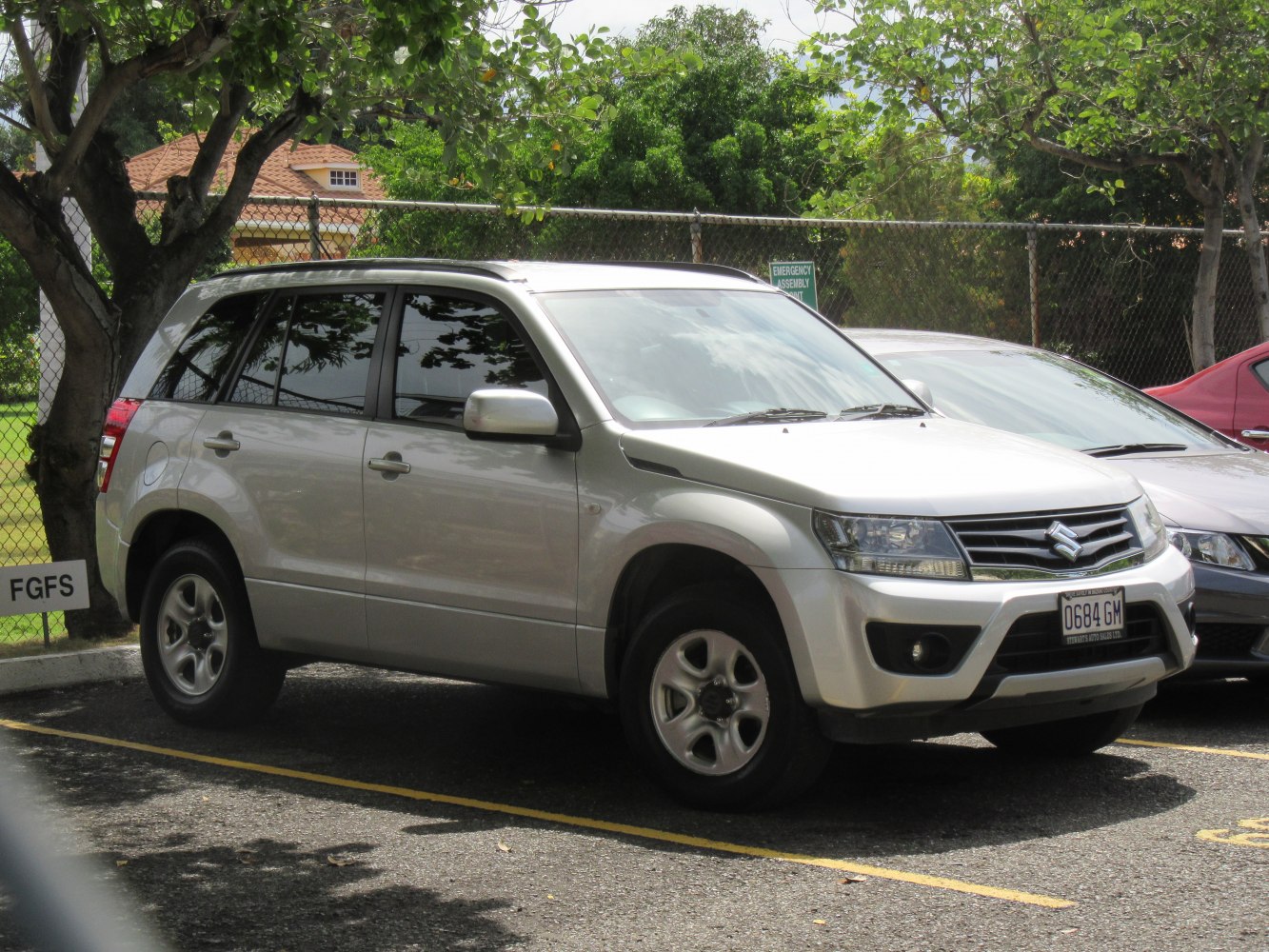 Front side view of silver SUV with alloy wheels and tinted windows