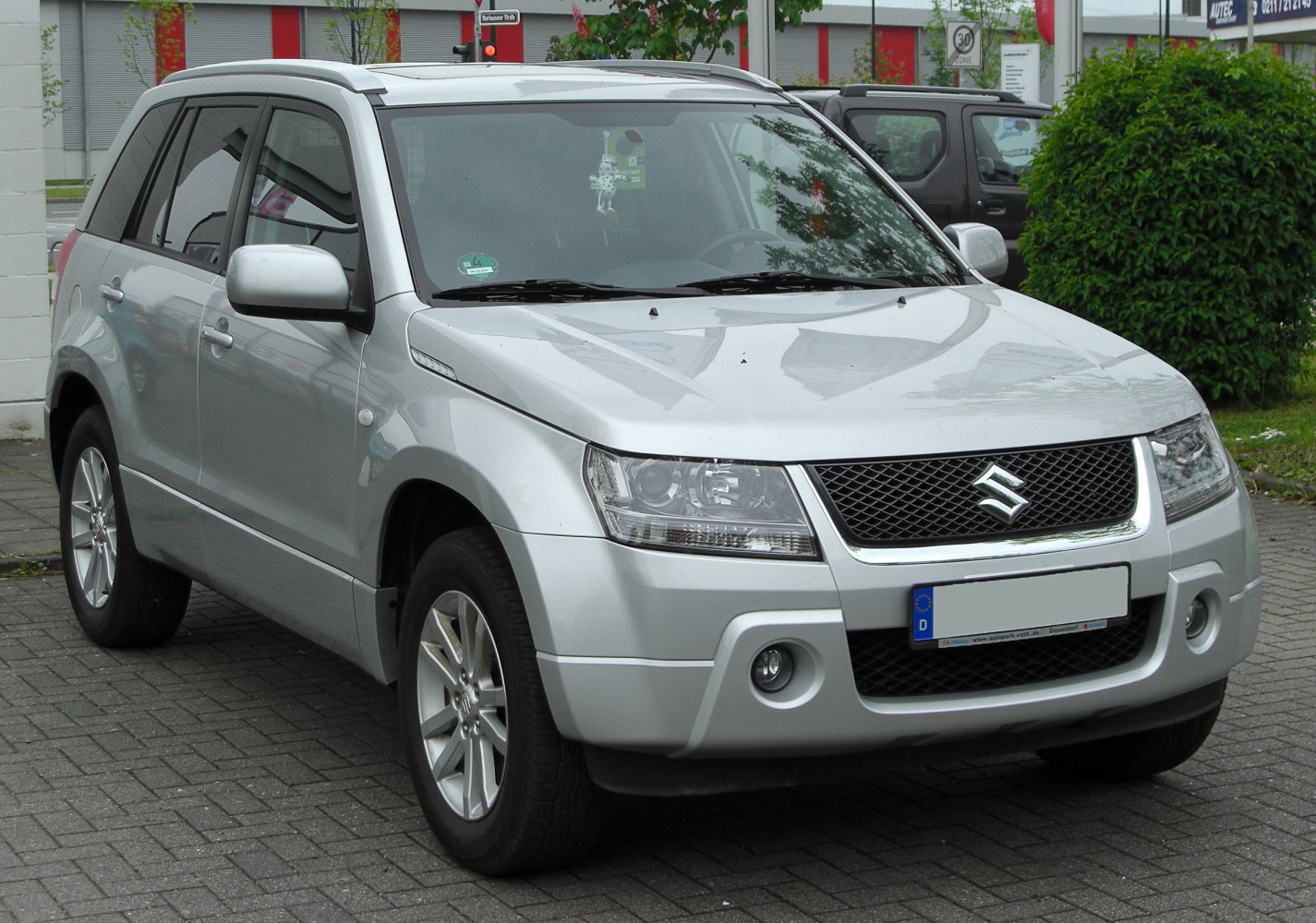 Front design with mesh grille, headlights, fog lights, and alloy wheels