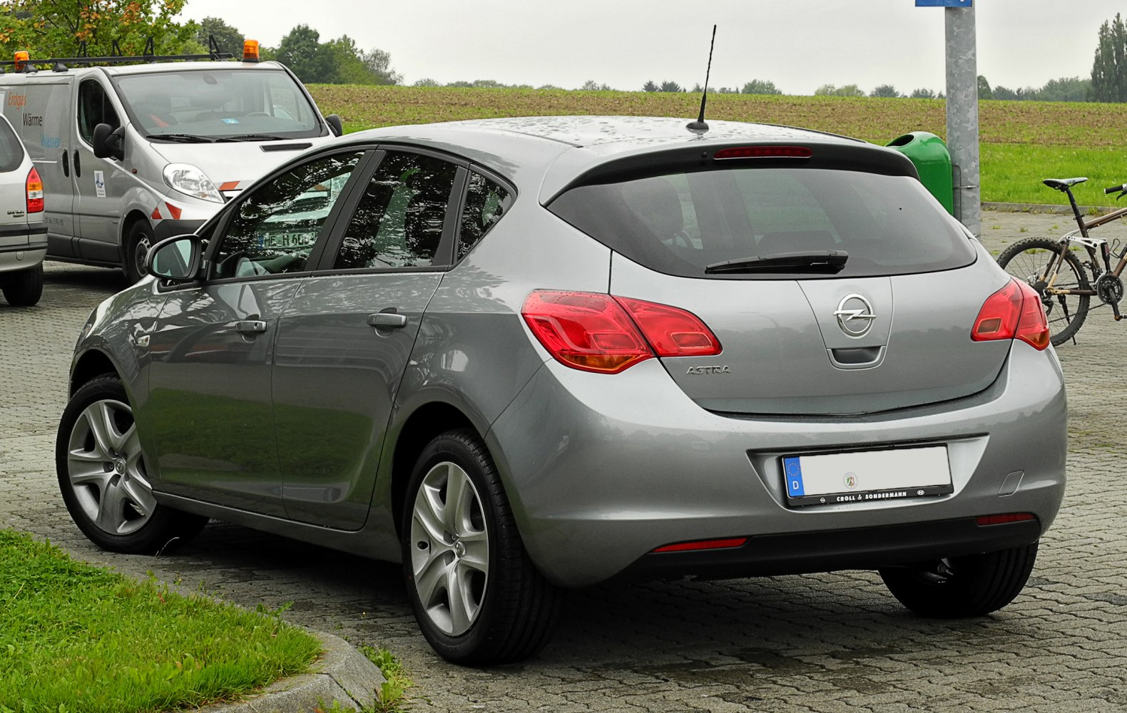 Rear view of silver hatchback with distinctive taillights and rear spoiler