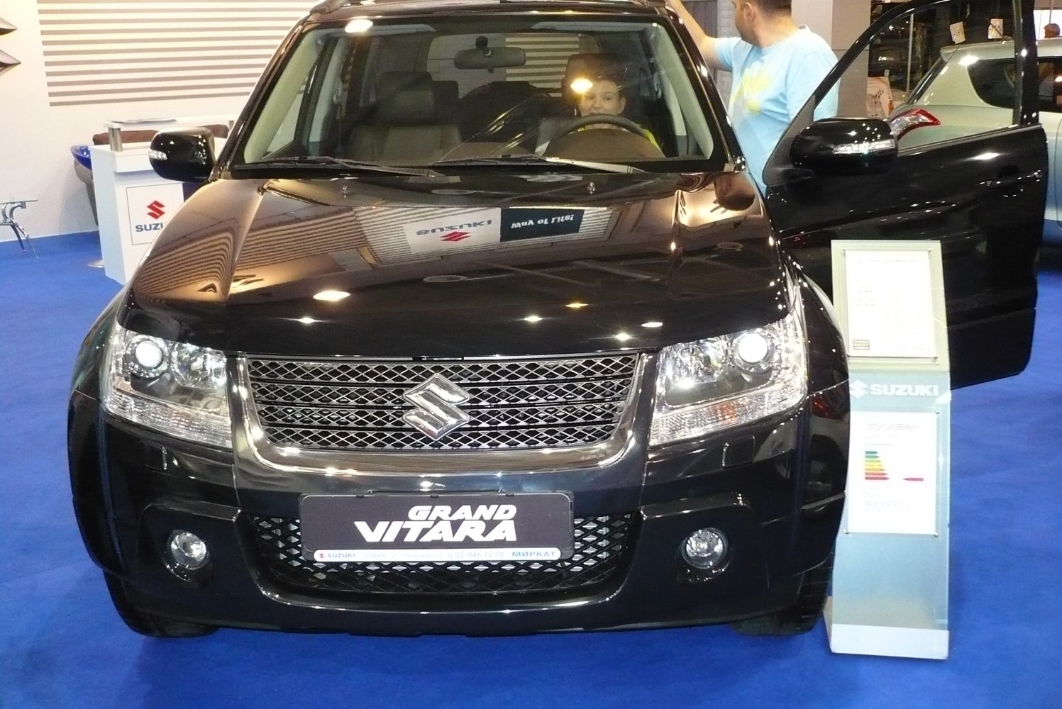 Detailed front grille and headlights with open passenger door.