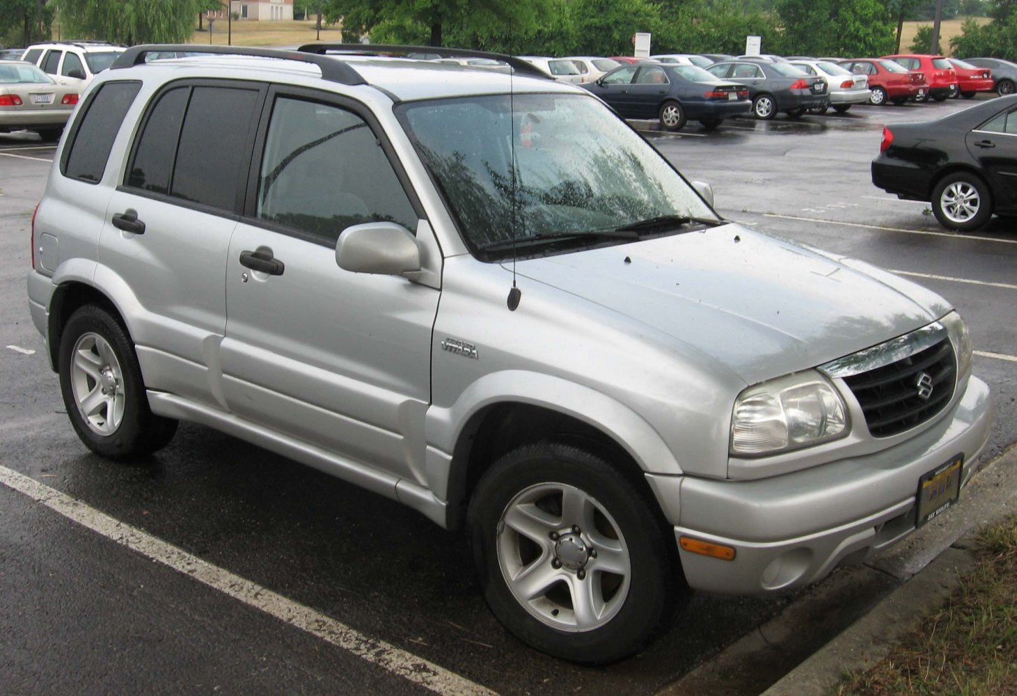 Silver mid-size SUV with roof rails, alloy wheels, and black door handles