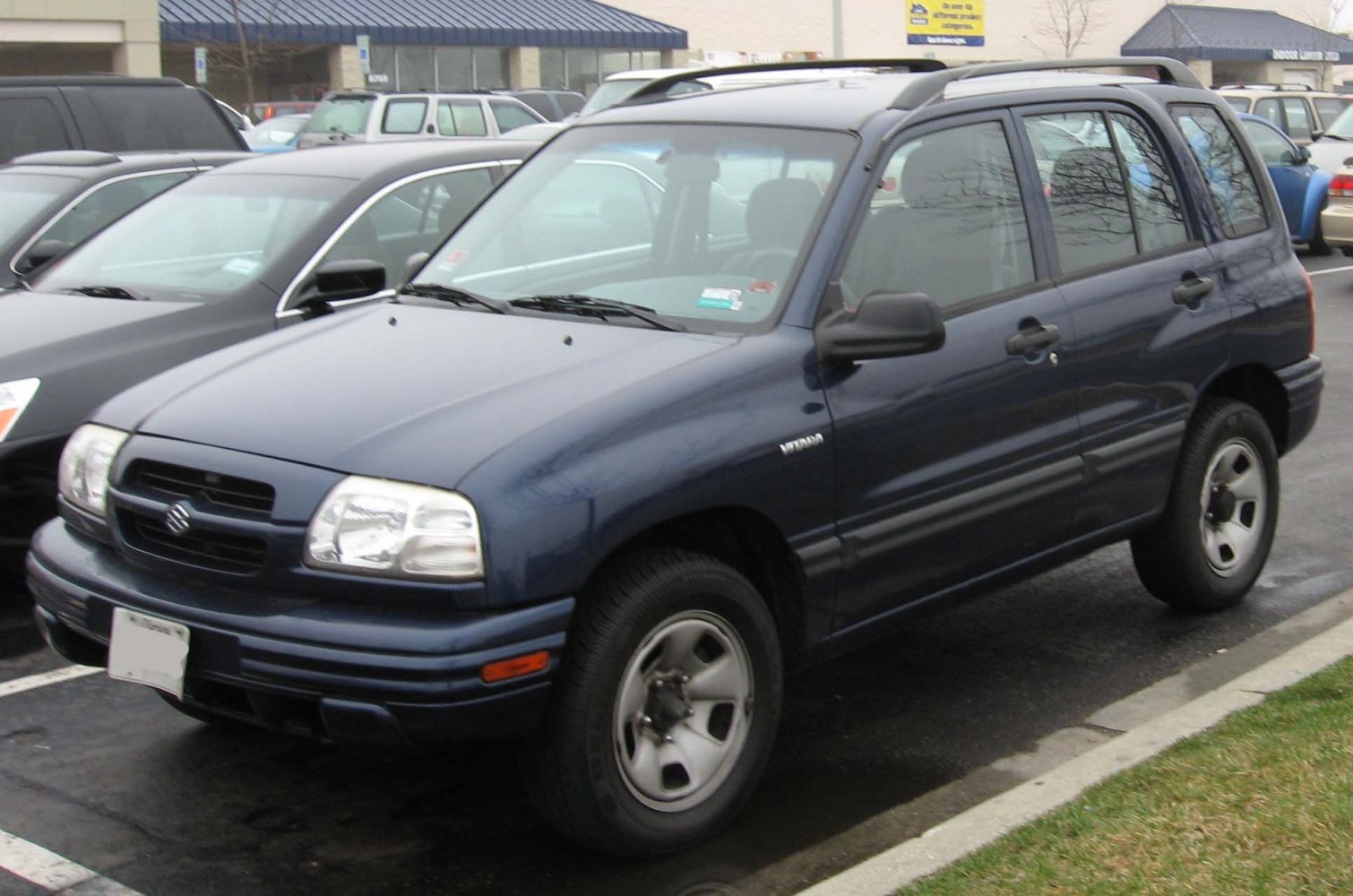 Front side view of rugged SUV with distinct headlamps and alloy wheels
