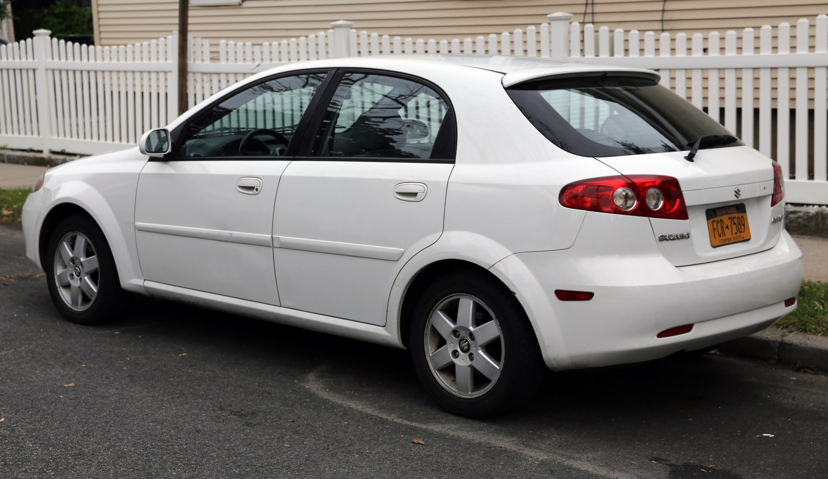 Rear side view of hatchback with distinctive tail lights and five-spoke wheels