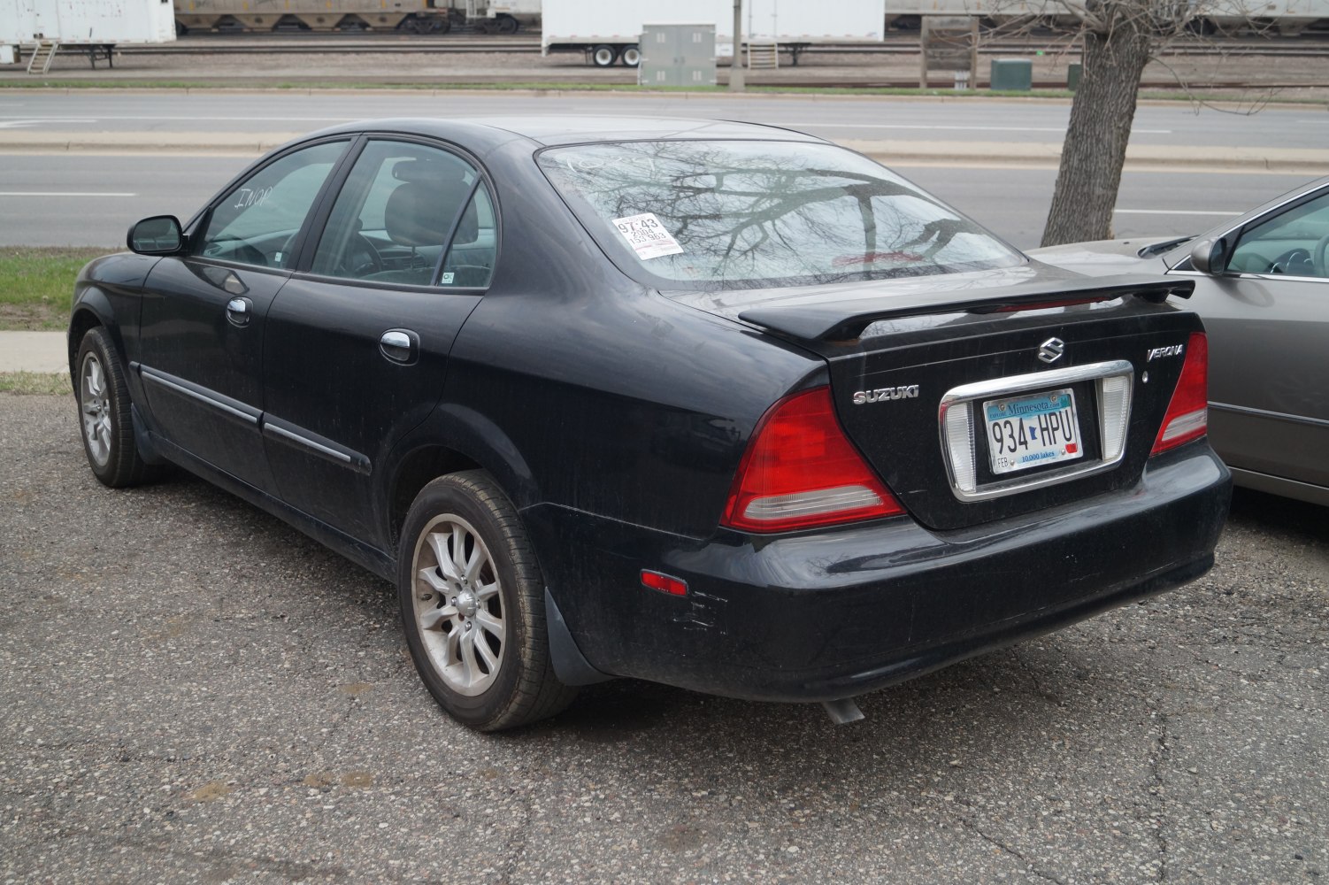 Rear view of sedan with spoiler and alloy wheels