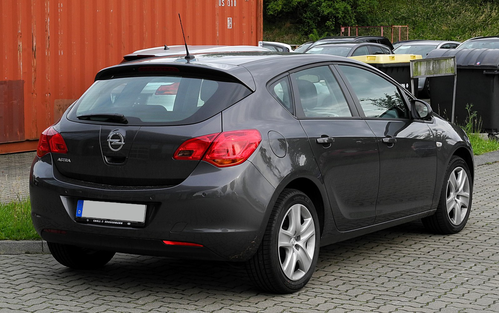 Rear and side hatchback view with taillights and alloy wheels
