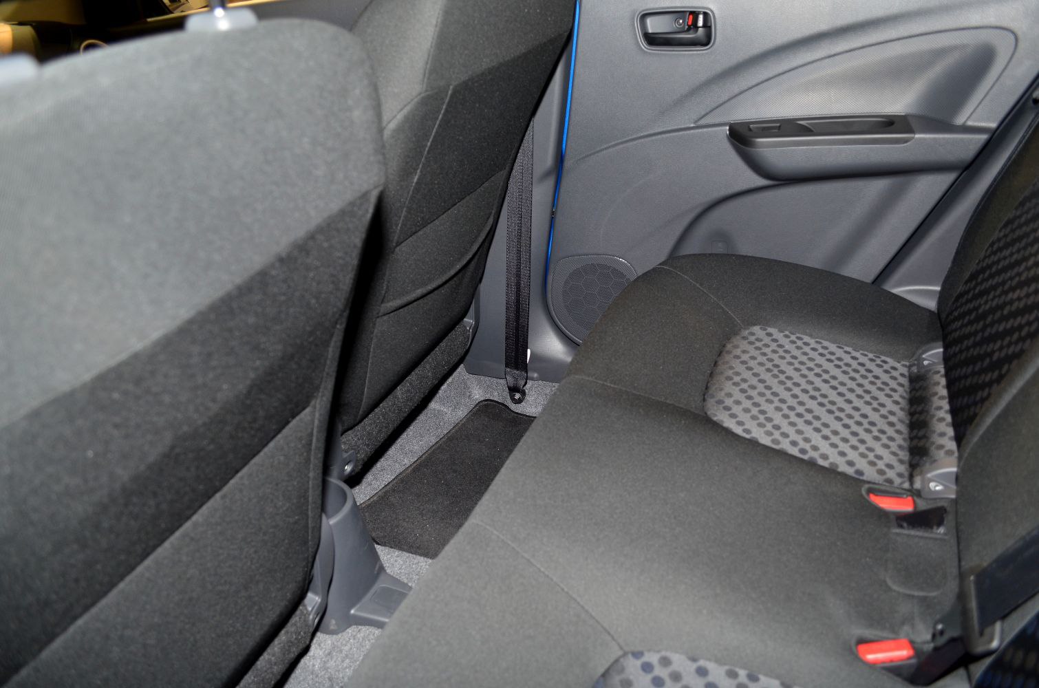 Rear seats and door panel of a compact car interior