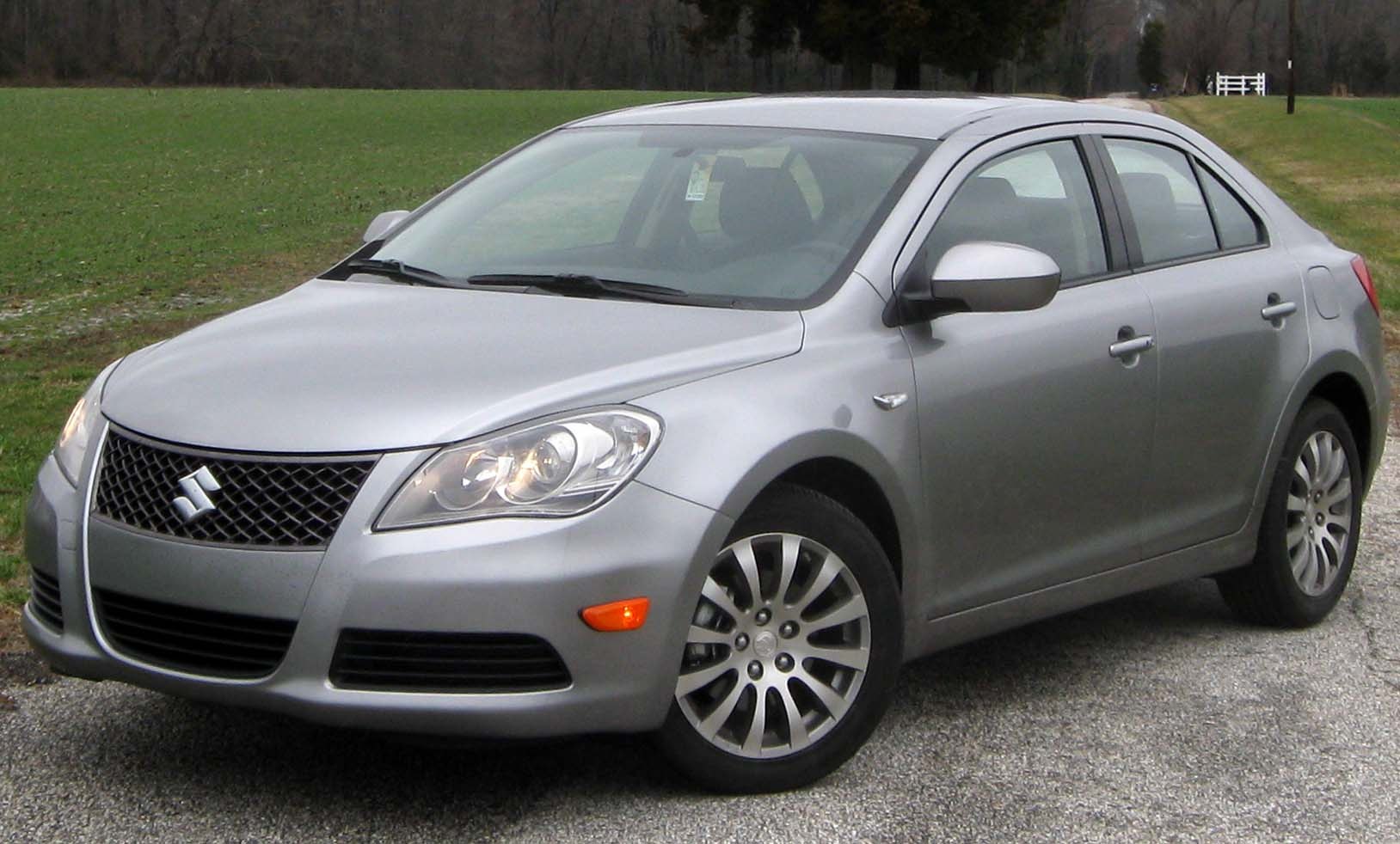 Front-side view of sedan with alloy wheels and headlights on
