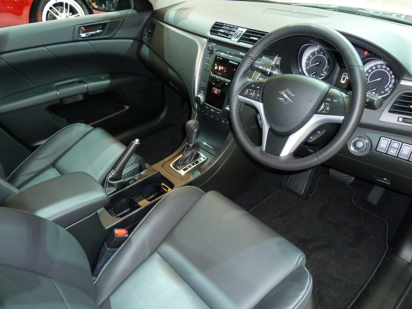 Dashboard, steering wheel, and leather seats of a vehicle interior