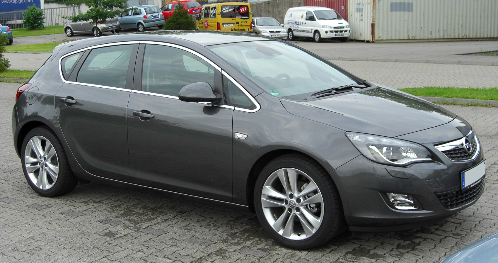 Gray hatchback front side view with alloy wheels and distinctive headlights
