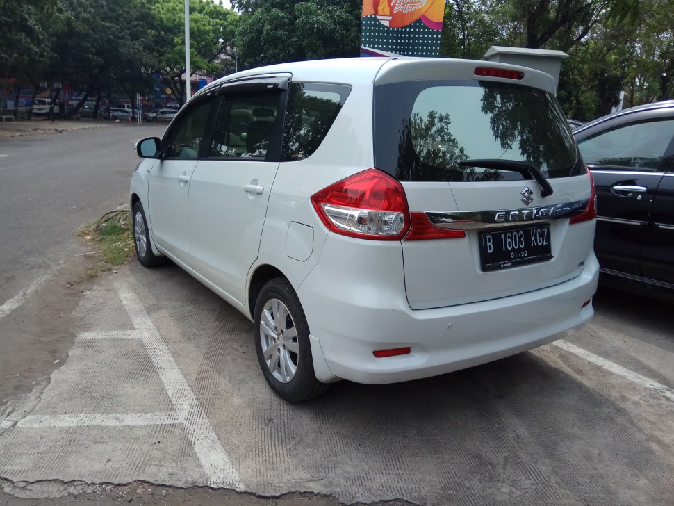 Rear view of white MPV with distinctive tail lights and rear hatchback