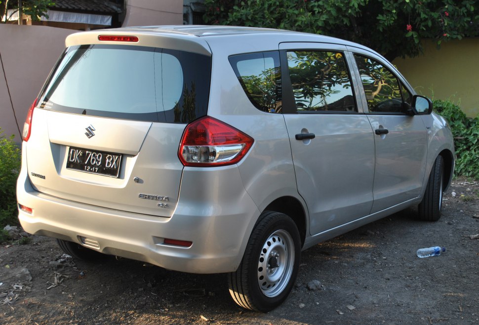 Rear view of silver compact MPV with vertical tail lights and steel wheels