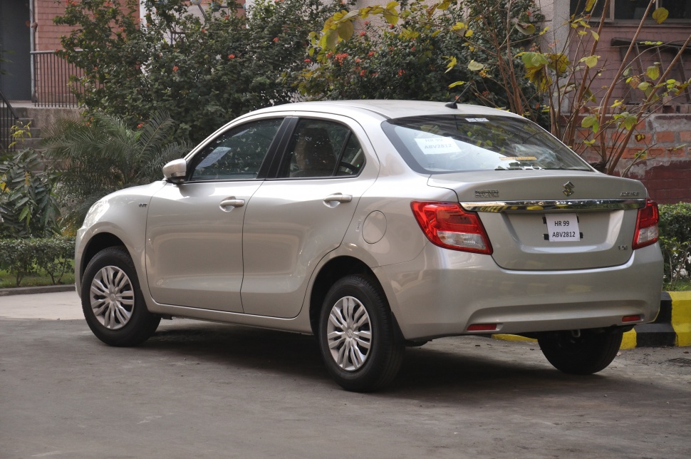 Rear side view of compact sedan with taillights and rear bumper