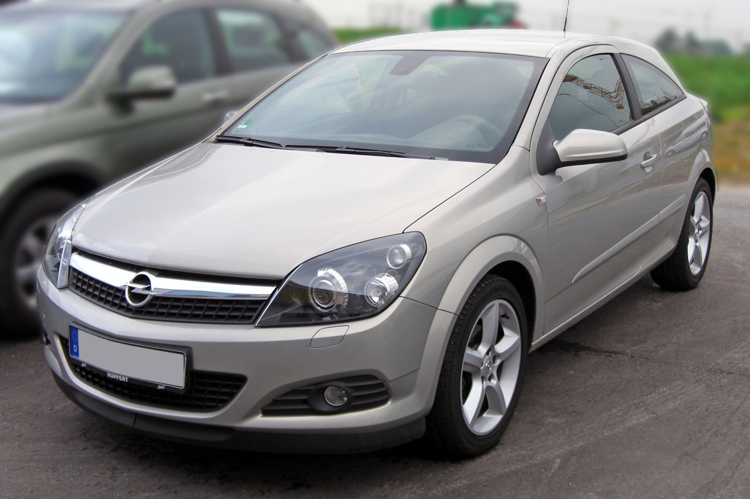 Silver coupe with unique headlights, 5-spoke alloy wheels, front-side view
