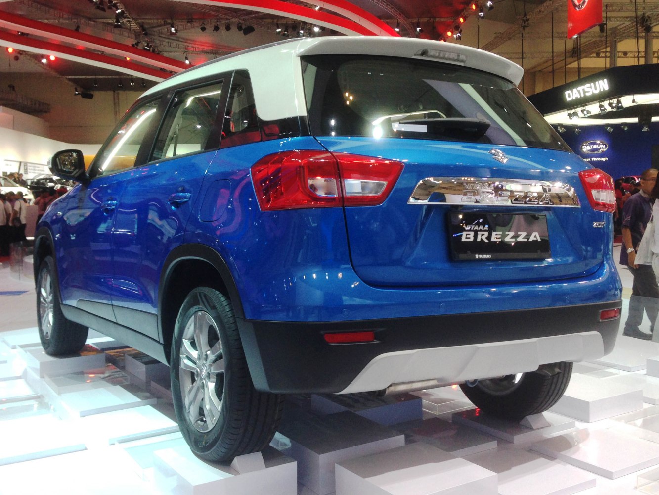 Rear three-quarter view of blue SUV with white roof and alloy wheels