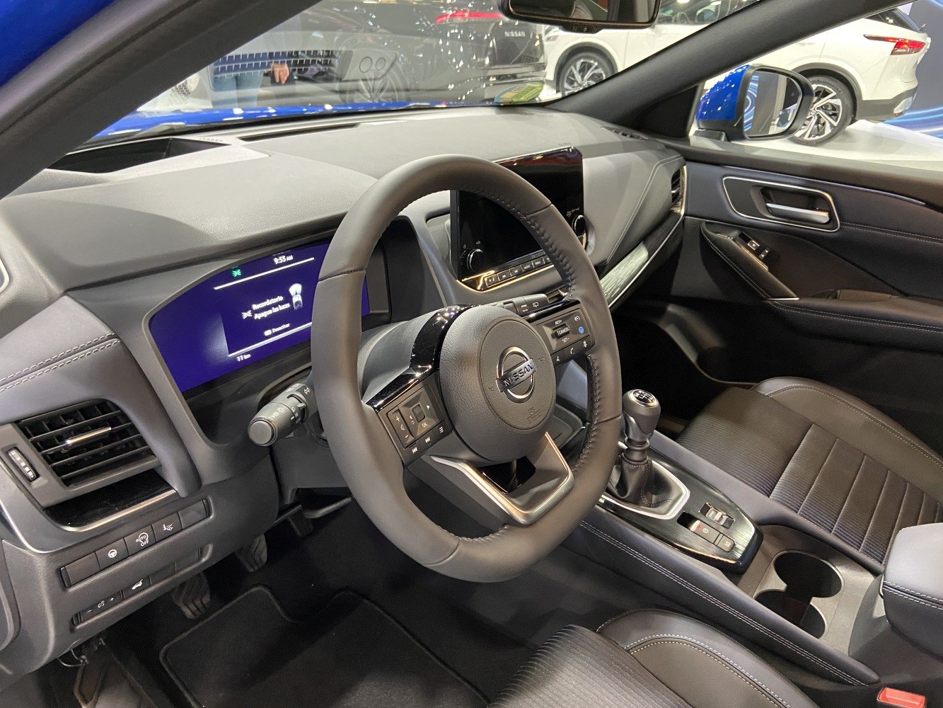 Modern car interior with manual gear stick and digital displays