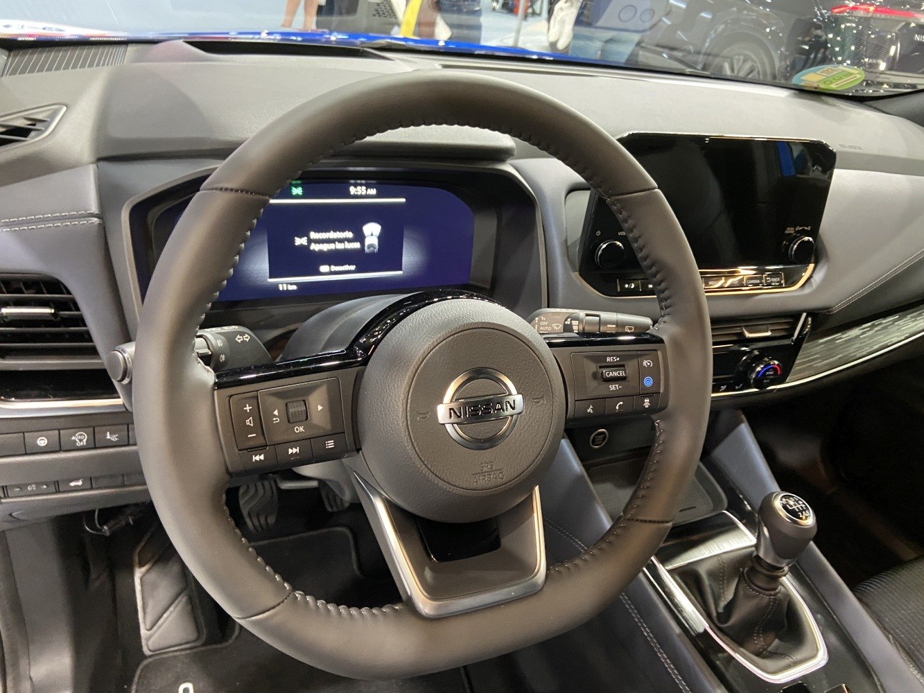 Modern steering wheel with controls and manual gear shift in SUV interior