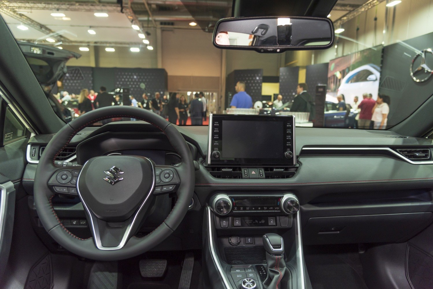 Modern steering wheel with multifunction controls and central touchscreen dashboard display