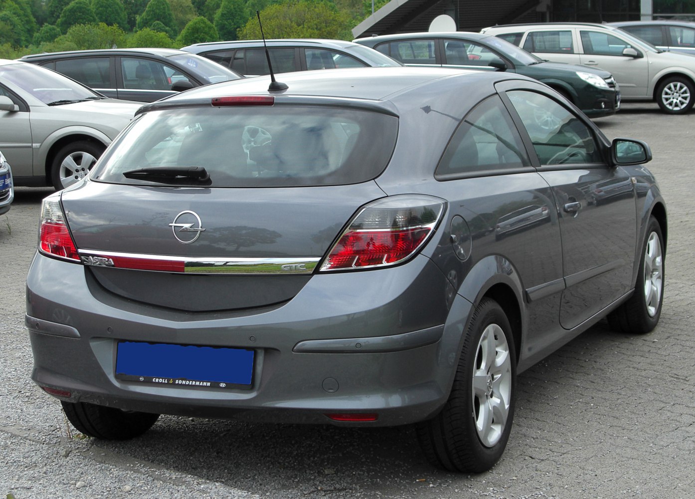 Rear view of hatchback with distinct taillights and sporty roof spoiler.