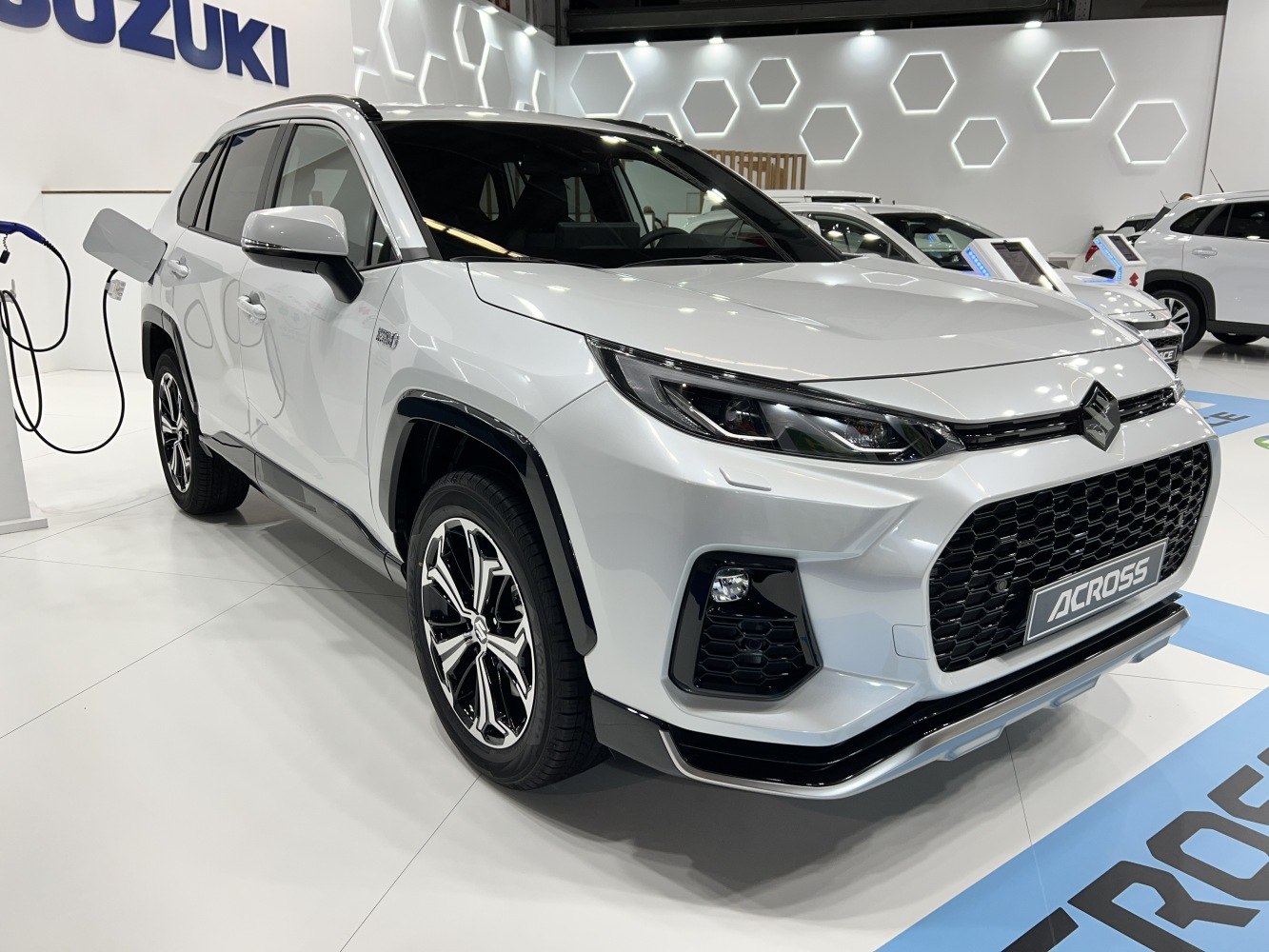 Front angled view of hybrid SUV with open charging port