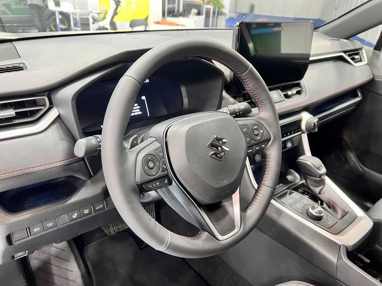 Steering wheel and center console with controls and touchscreen display