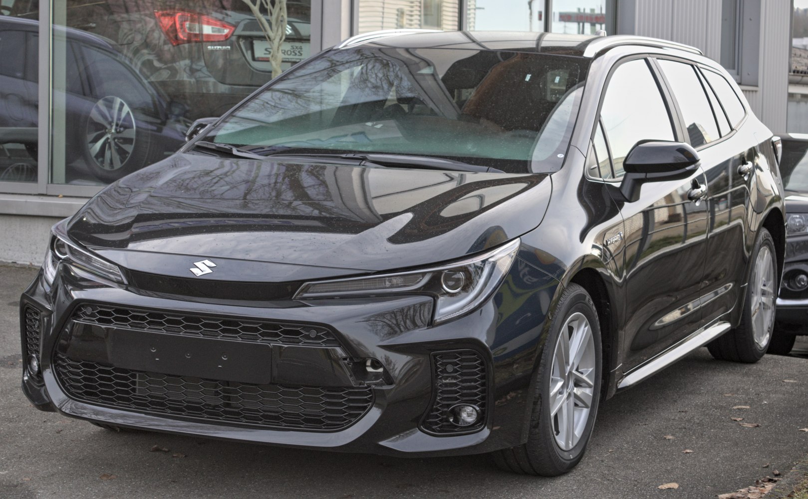 Black hybrid hatchback with sleek LED headlights and alloy wheels