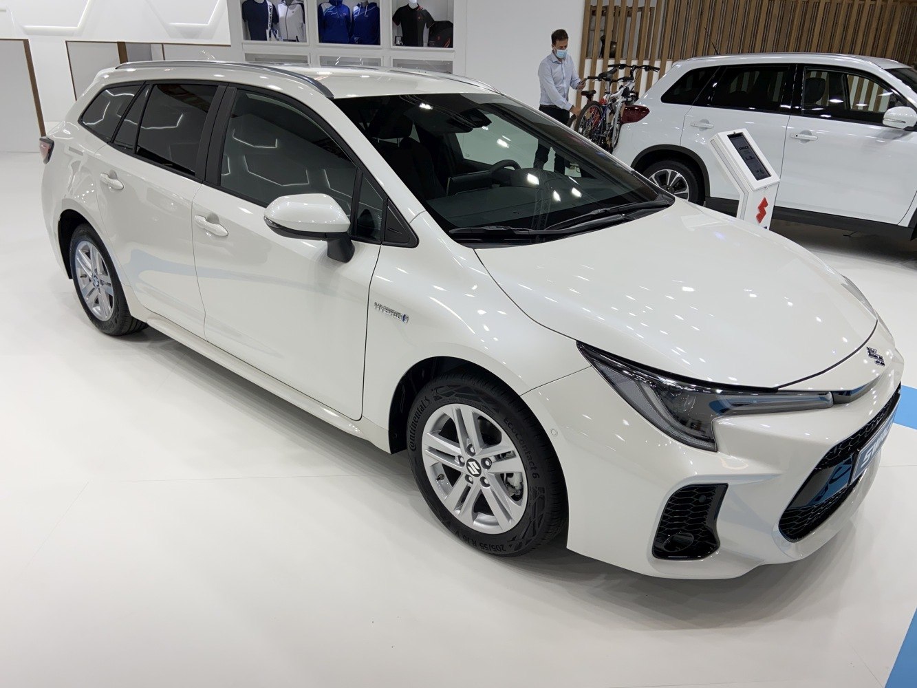 Front three-quarter view of hybrid wagon with sleek headlights and alloy wheels