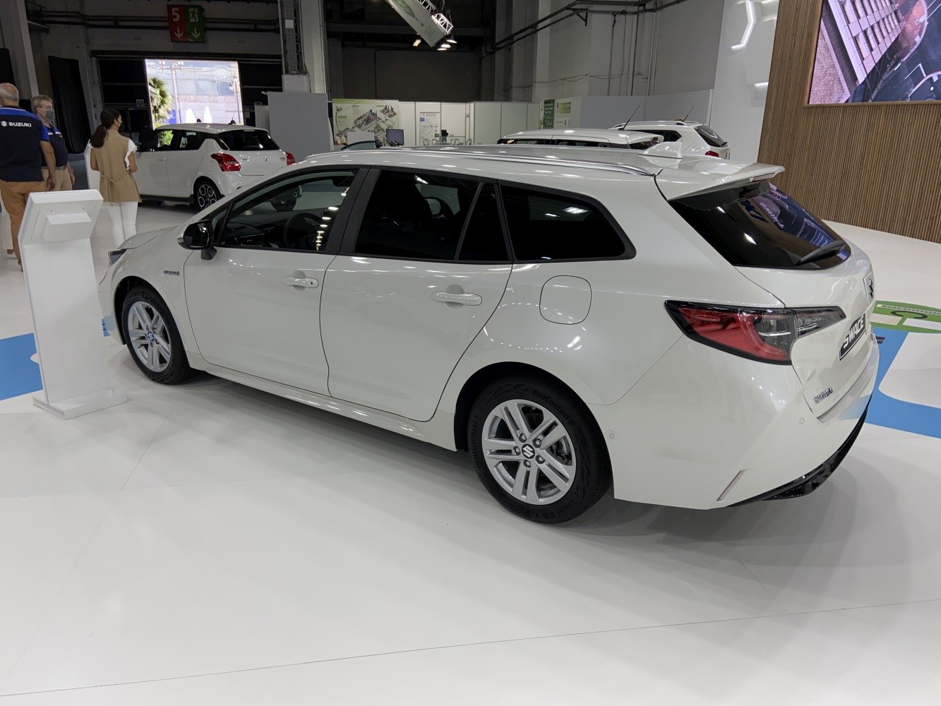 White station wagon rear side view with alloy wheels and hybrid badge