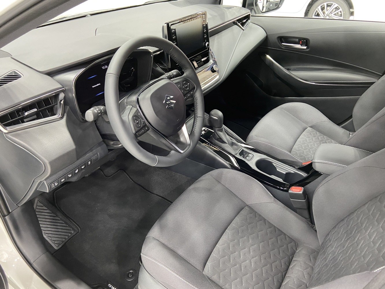 Inside car cabin with steering wheel, dashboard, seats and center console